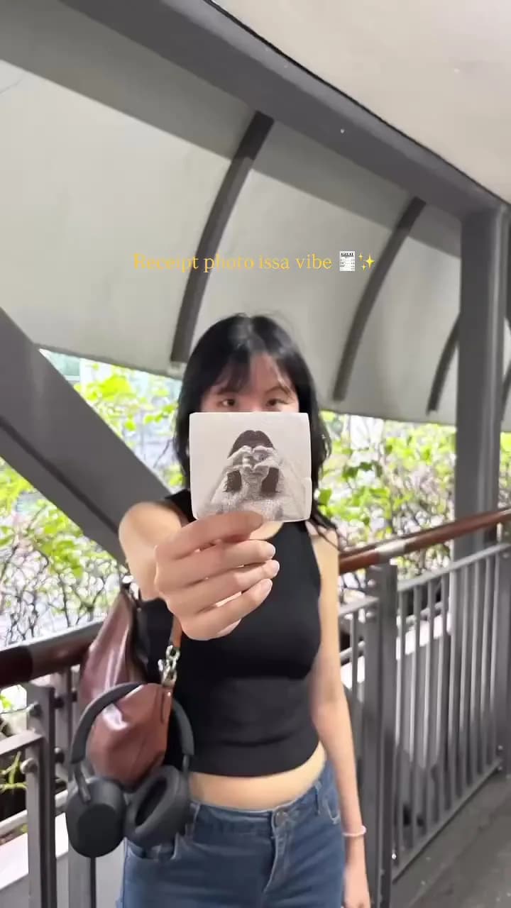 Customer holding a photo strip outdoors