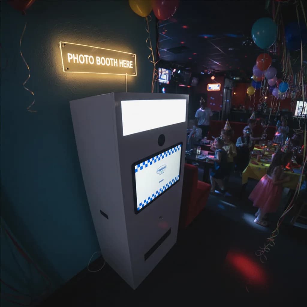 Portable photo booth machine inside a bar on a birthday event
