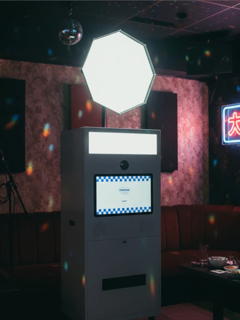 Portable photo booth machine inside a karaoke bar