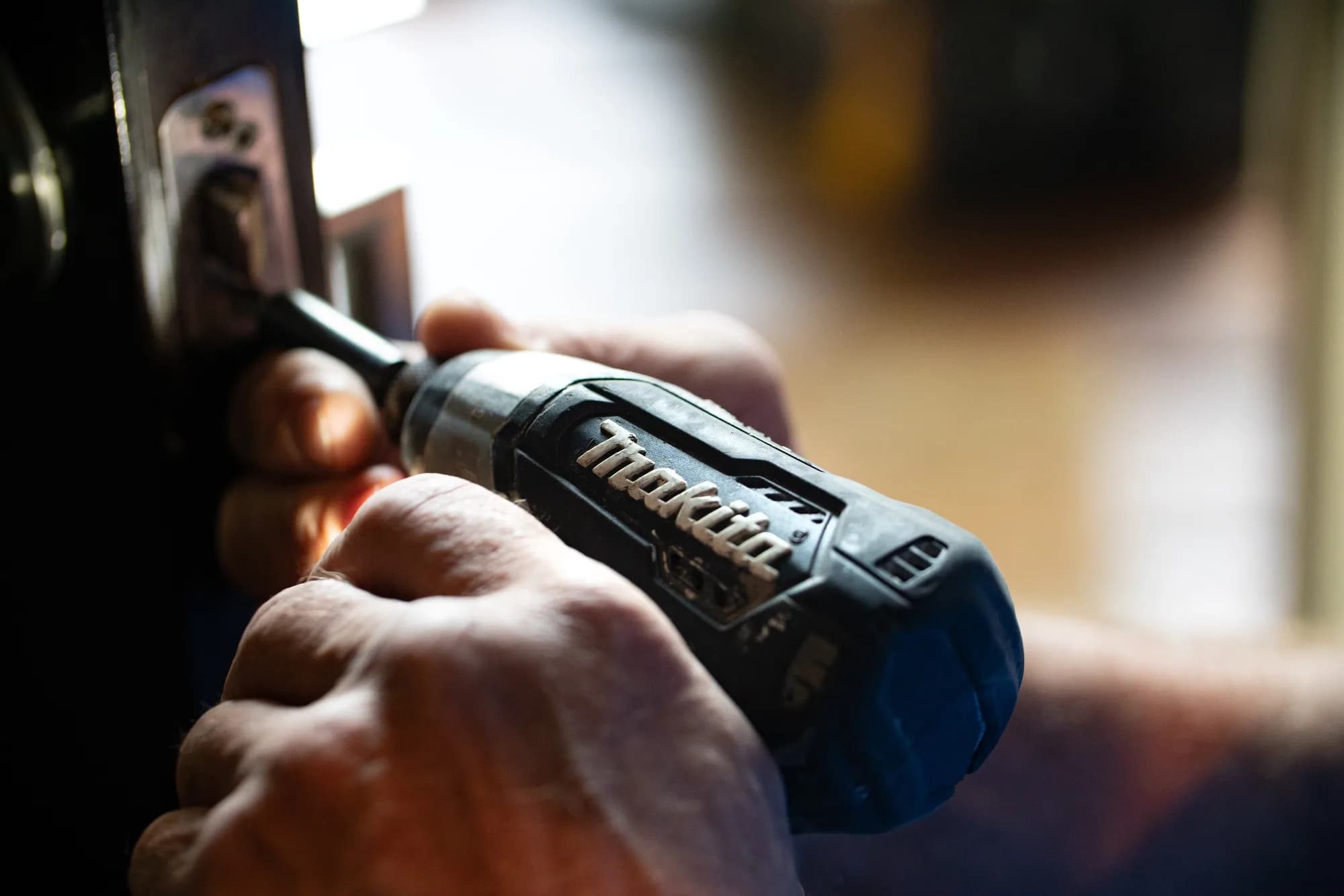 A person using a Makita screwdriver