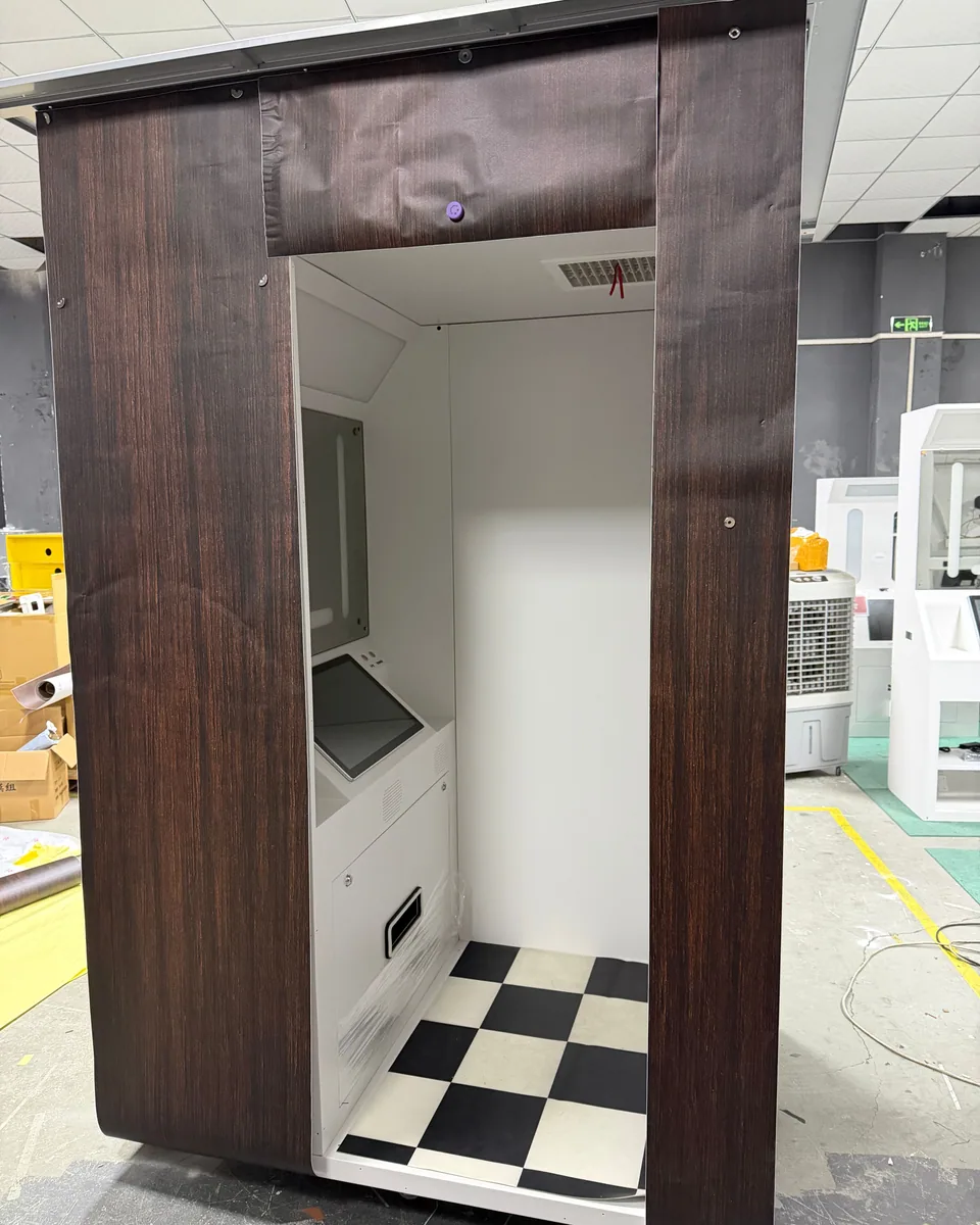 Enclosed photo booth with a wood-grain exterior and checkerboard floor