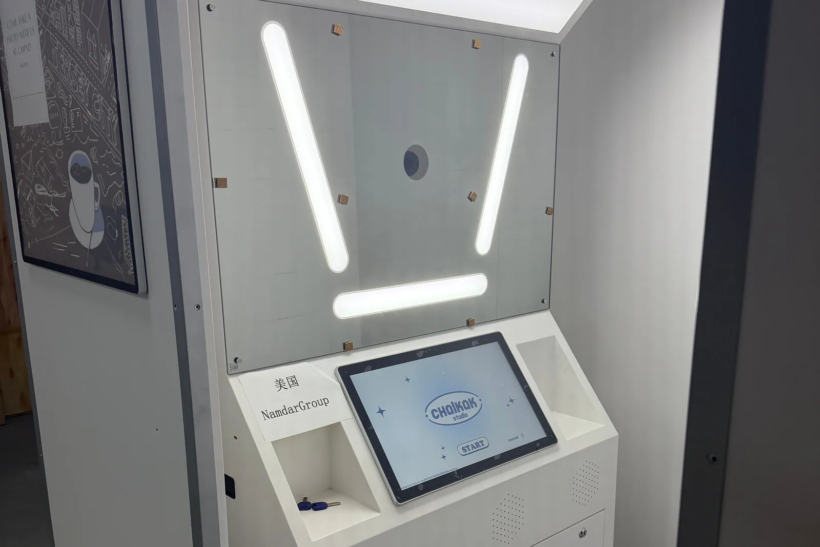 Korean-style photo booth machine with its LED light frame, touchscreen and camera