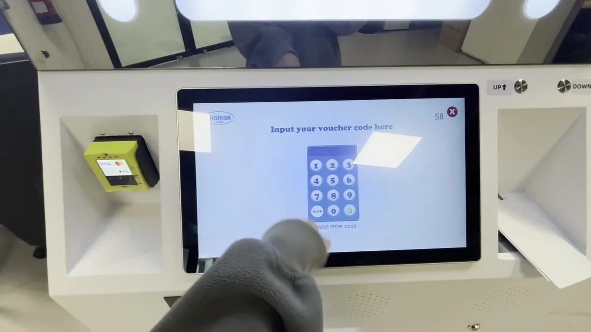 Voucher code entry screen on a photo booth touchscreen